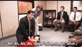 A humorous image from tv show "the office" shows people giving CPR at the correct rate.