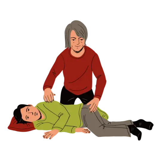 A woman places a pillow under a man's head and puts him in a recovery position to help manage his seizure.