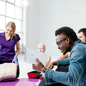 a happy man has a notebook at a first aid class