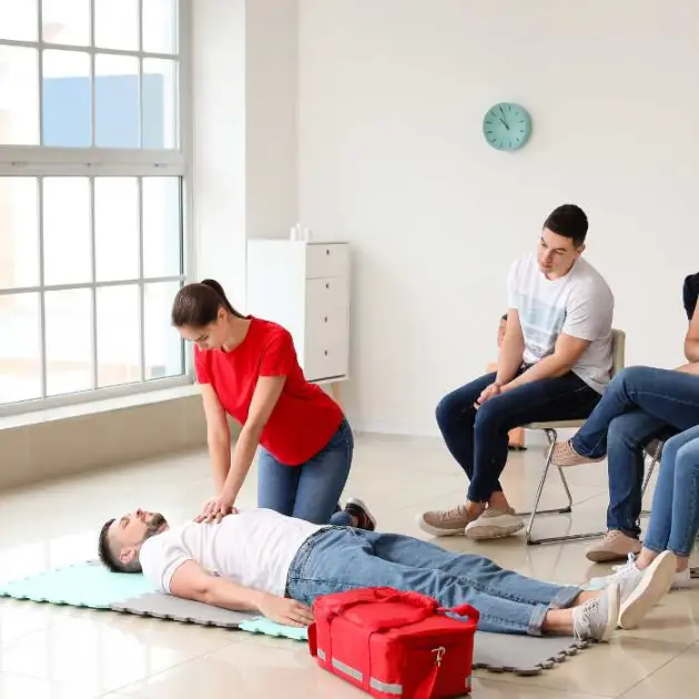 a trainer demonstrates CPR on a student