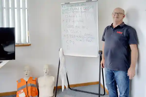 tony van der weiden stands with 2 first  aid manakins
