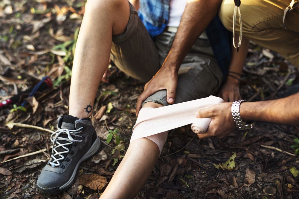 Providing basic first aid, such as a knee bandage shown here, becomes more complicated when help is a long way away. Our HLTAID013 accredited course gives you the skills to manage this kind of emergency.